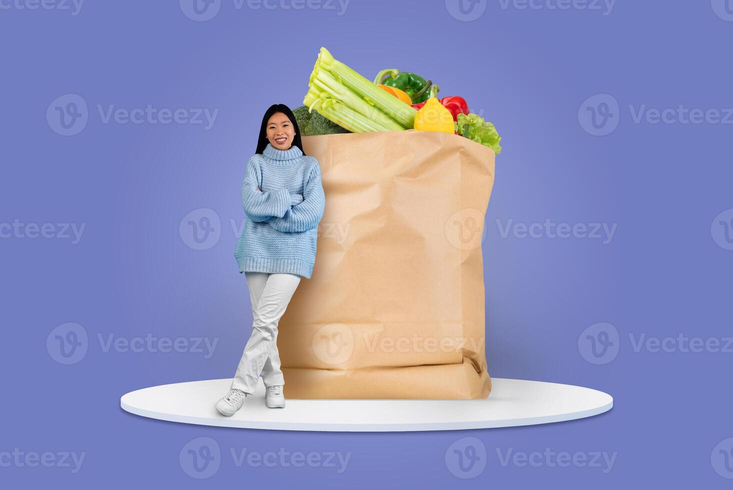 A customer stands beside a large paper bag filled with fresh groceries. This scene highlights the growing trend of shopping for food from home, emphasizing convenience and safety. photo