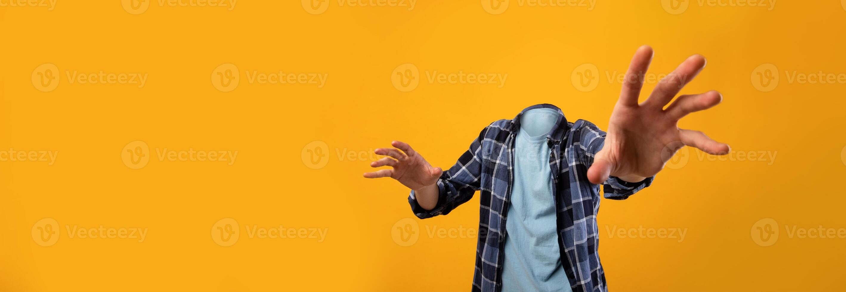 Engaging visual features headless individual extending his arms, set against a bright yellow backdrop. This unique concept highlights the essence of isolation and dynamic lifestyle choices. photo