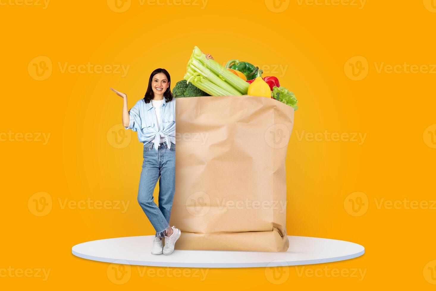 A customer stands next to a large paper bag filled with fresh produce. The vibrant background highlights the new normal of grocery shopping and delivery in today's world. photo