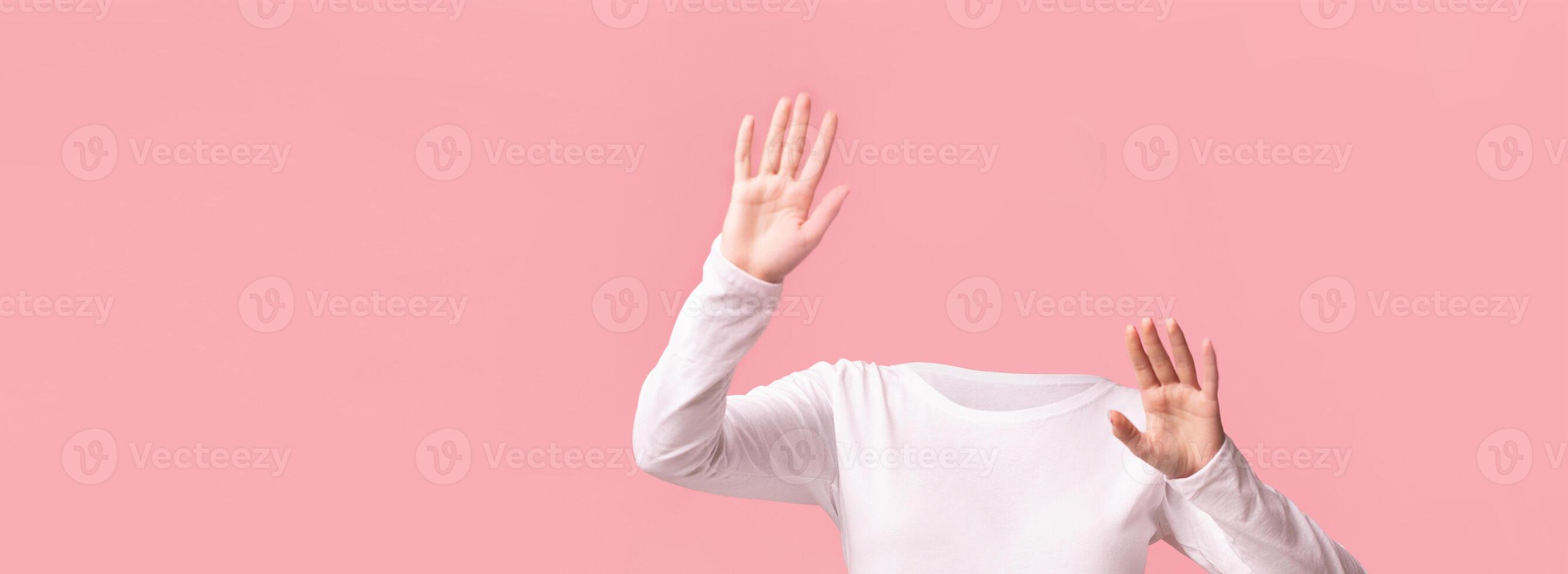 Hands reaching outward against a soft pink backdrop convey a sense of isolation and creativity. The absence of heads adds a unique twist, inviting imaginative interpretations. photo