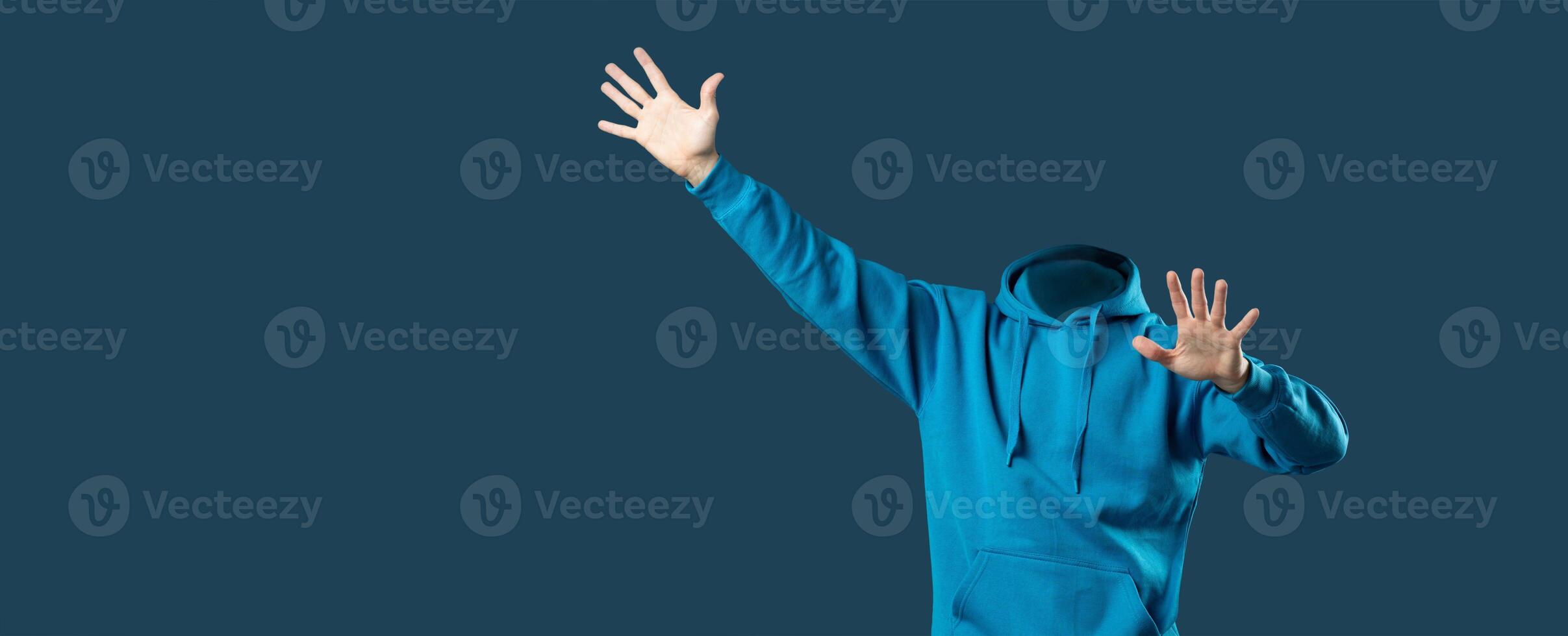A headless person wearing a blue hoodie stands with arms raised in an isolated background. This collage offers ample blank space for creative use and highlights an intriguing lifestyle concept. photo