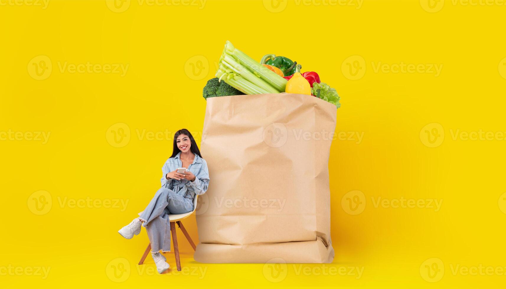 A customer sits comfortably beside a large paper bag filled with fresh vegetables and fruits, showcasing the new normal of grocery shopping and home delivery options. photo