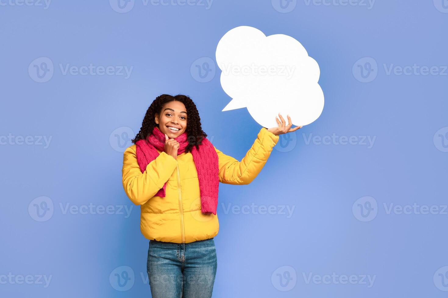 African American Lady Holding Blank Speech Bubble Above Head Posing Over Purple Studio Background, Smiling To Camera. Let Me Think, Empty Speech-Bubble Mockup Concept photo