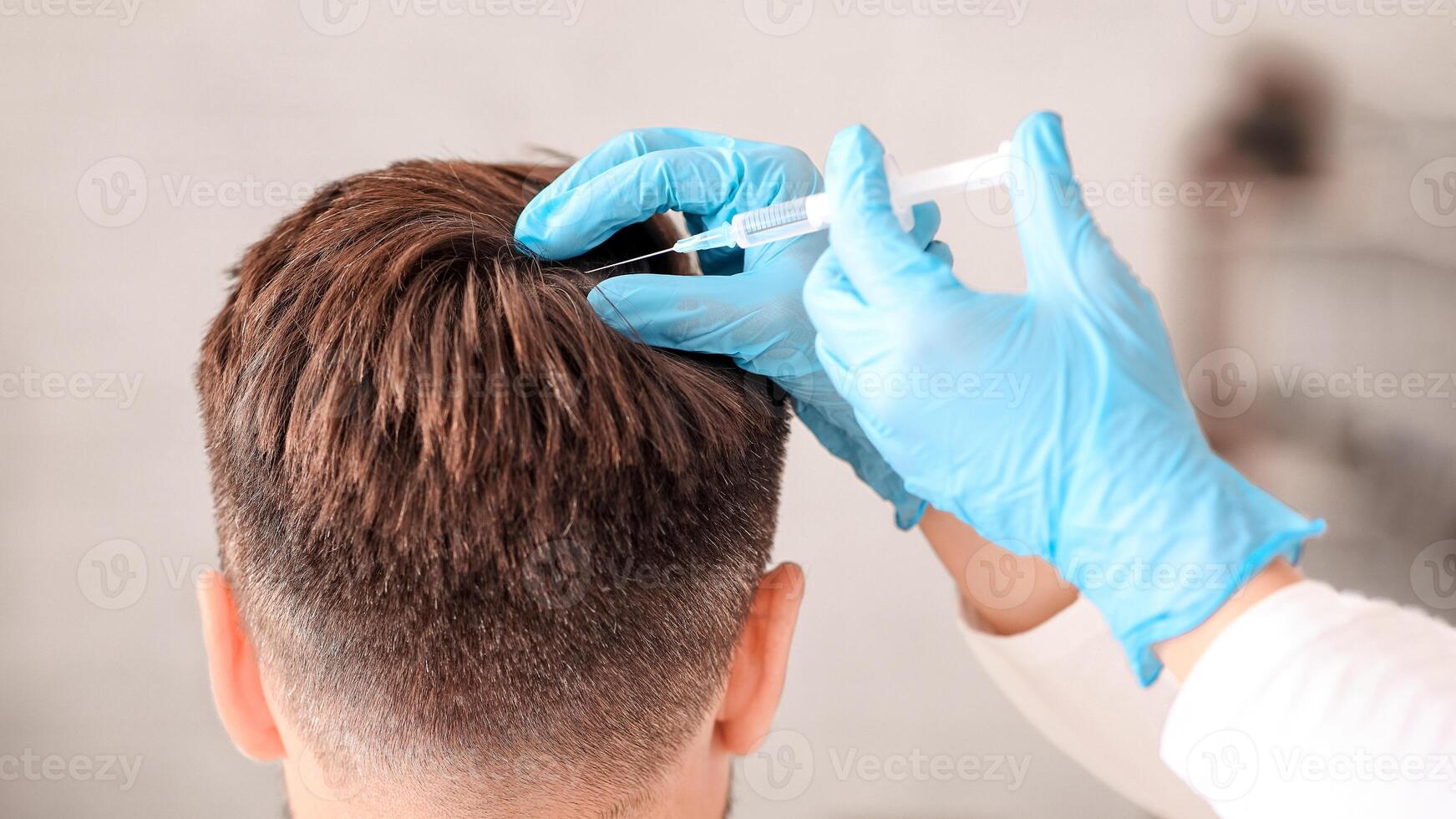 Back view of unrecognizable middle aged man getting hair treatment at beauty salon. Man having mesotherapy session at aesthetic clinic, therapist hands in gloves making injection in scalp, closeup photo