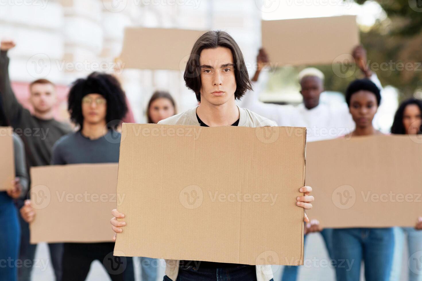 International group of students strikers with blank placards protesting on the street, fighting against corruption in school and free education. Student strike, campus strike concept photo