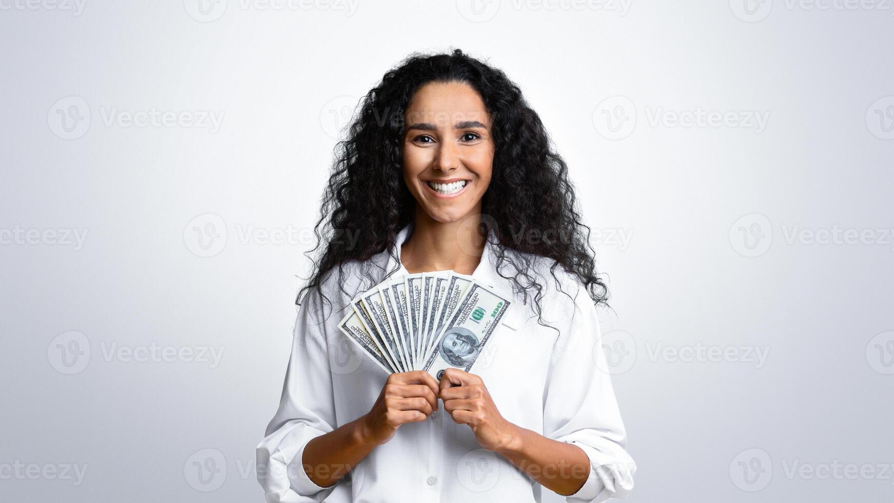 Happy Young Woman Holding Dollar Cash Posing Over Yellow Studio Background, Standing With Bunch Of Money, Got Big Prize Or Bonus, Received Profit From Deposit Investment, Smiling At Camera, Copy Space photo