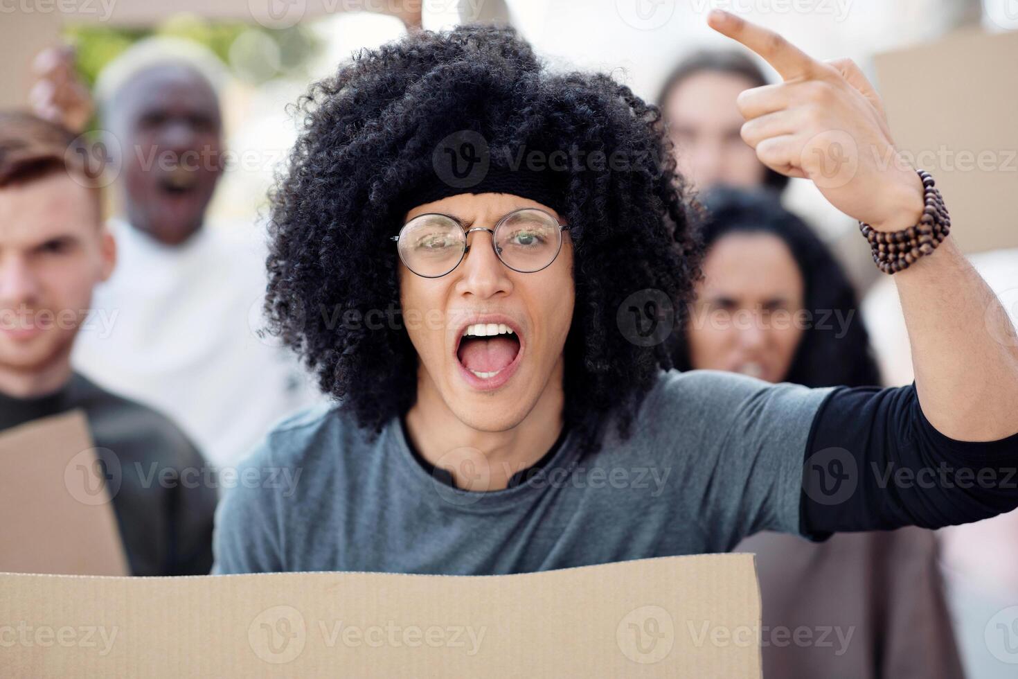 International group of men and women demonstrating protest against pollution, closeup. Angry young people striking for climate action, holding blank placards for slogans, yelling, pointing at camera photo