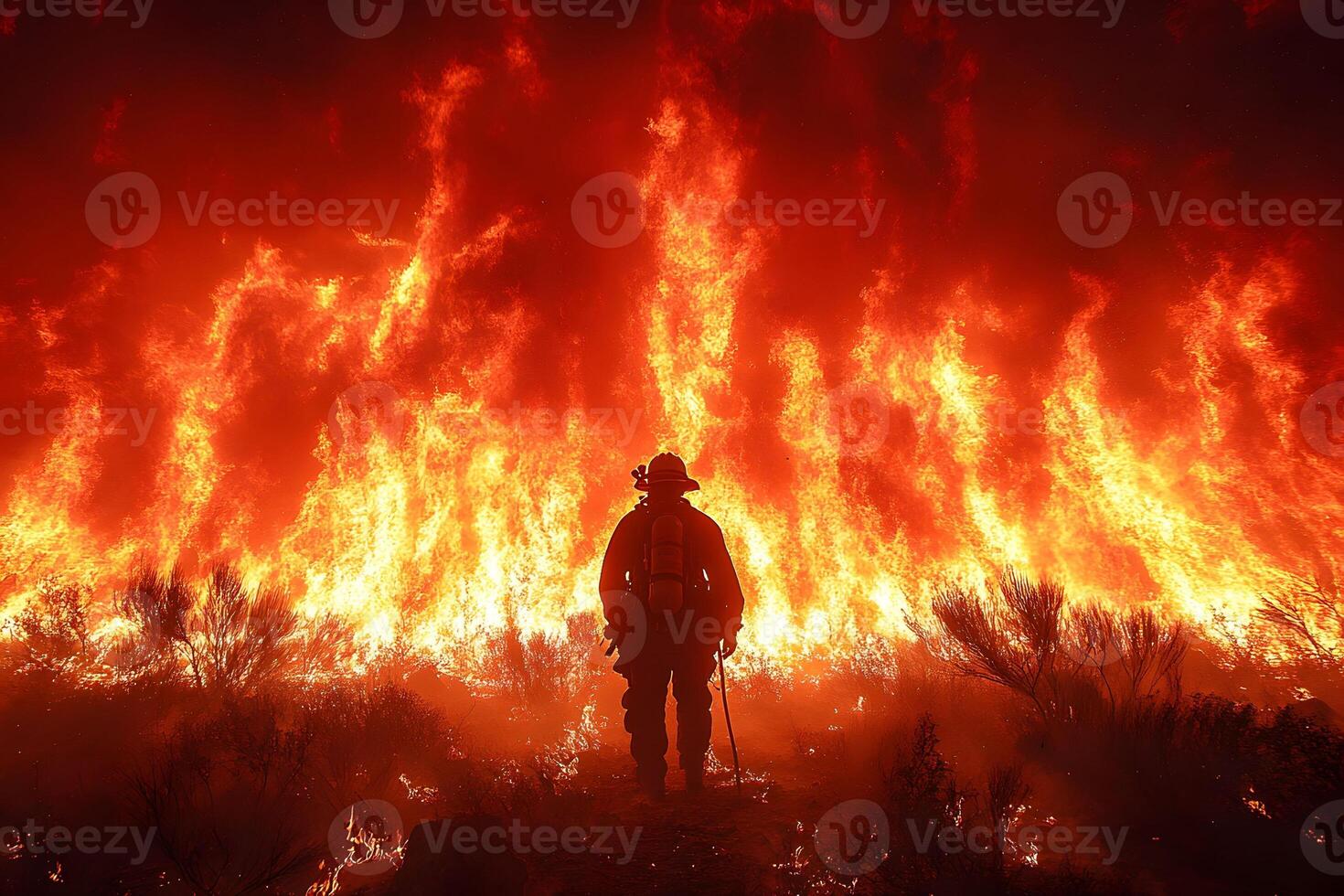 Brave Firefighter Battling Intense Wildfire Blaze in Forest Inferno Scene photo