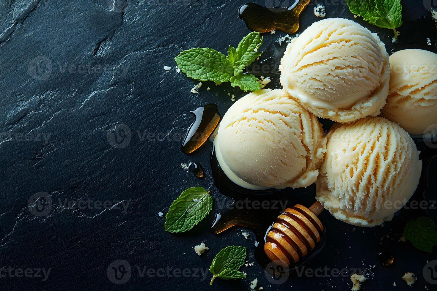Vanilla Ice Cream Scoops with Honey and Mint on Black Marble Background for Dessert Design photo