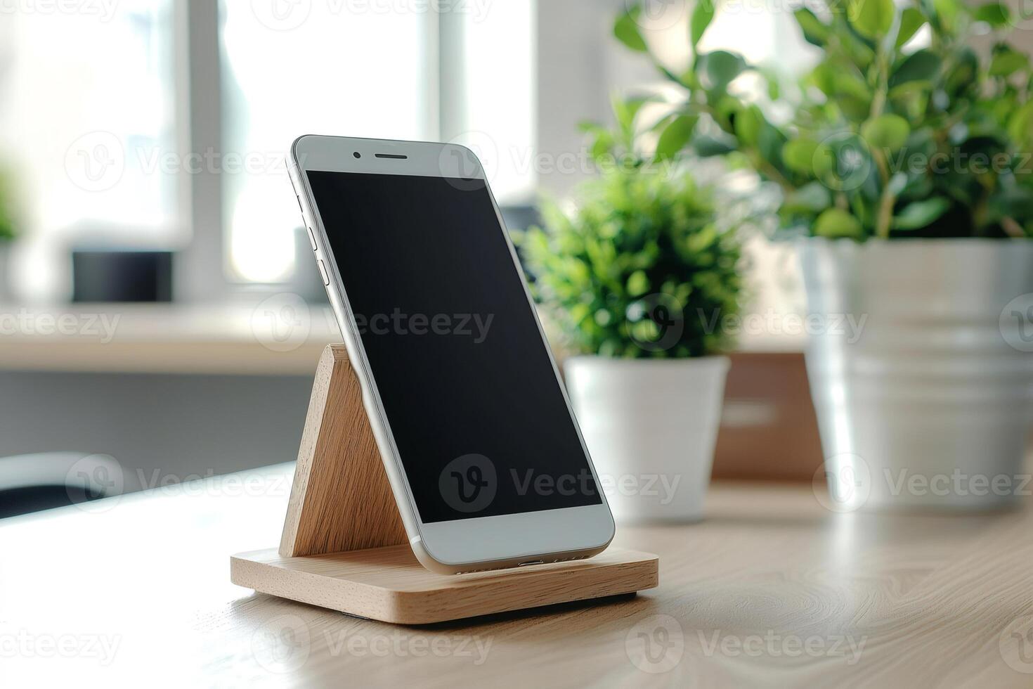 Modern smartphone resting on wooden stand in cozy home office setting photo