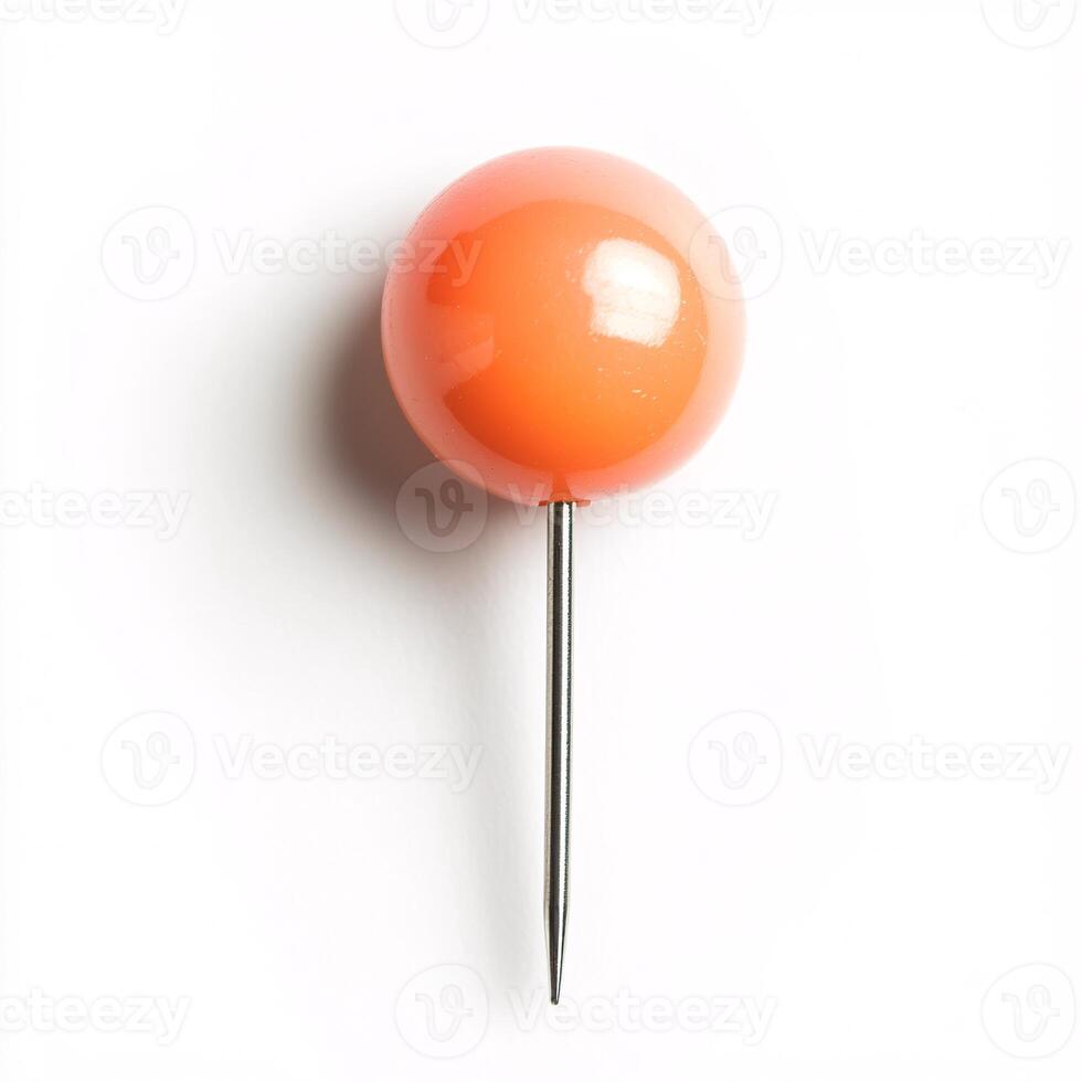 Bright peach-colored push pin standing alone on a clean white background photo