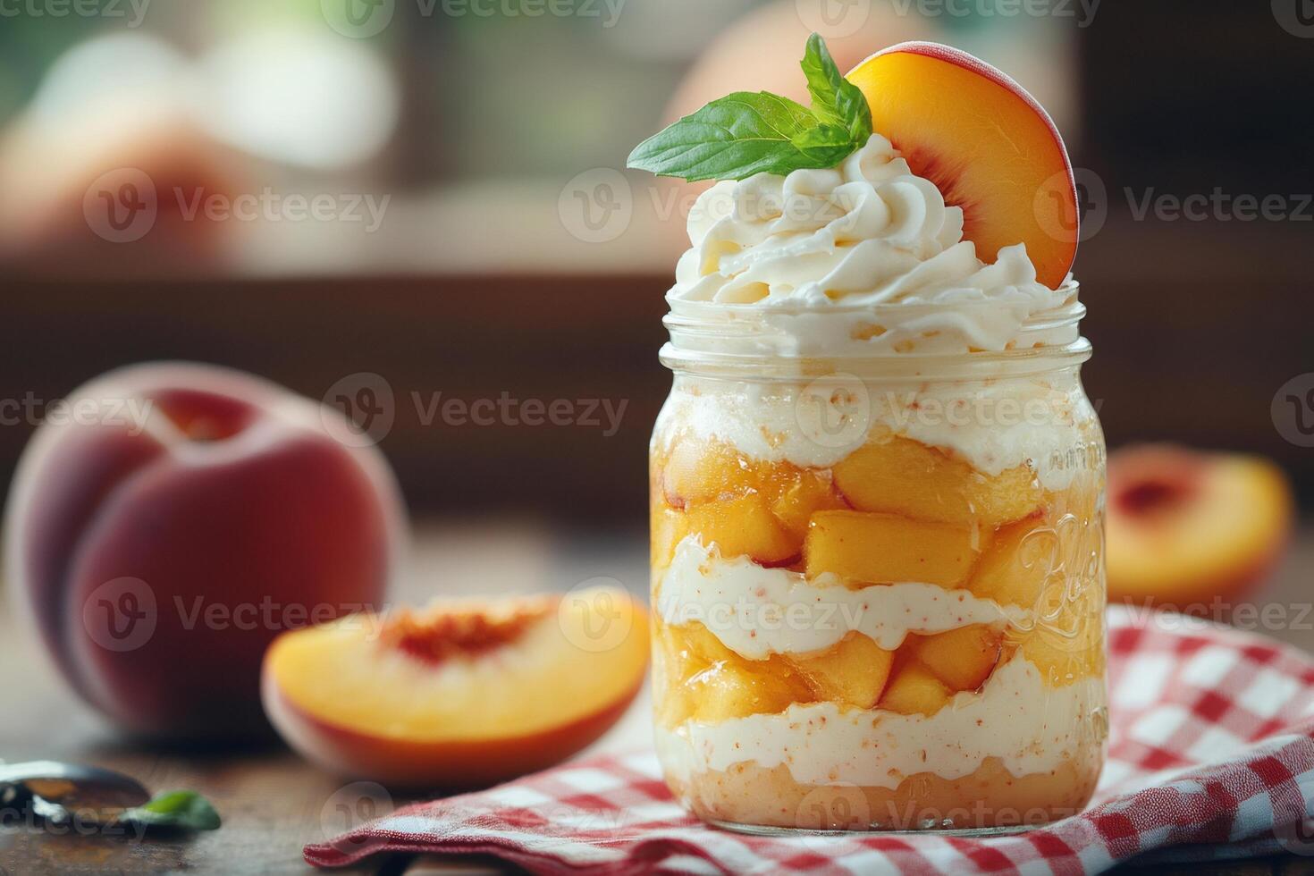 Peach dessert parfait with whipped cream and mint in a jar photo