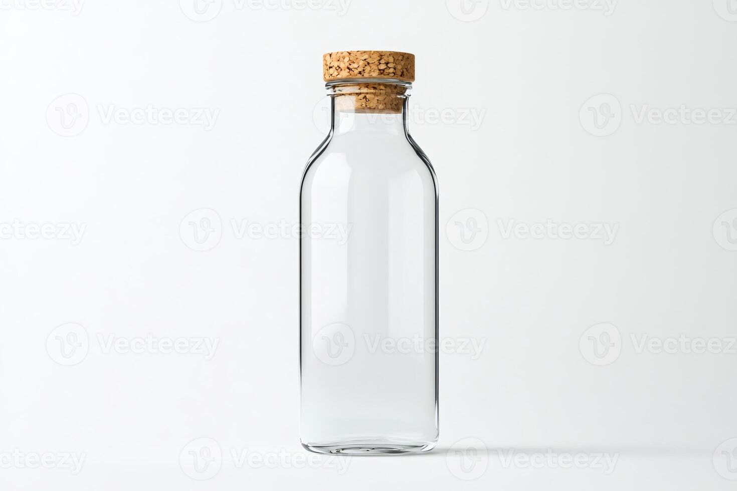 Empty glass bottle with cork lid standing on white background photo