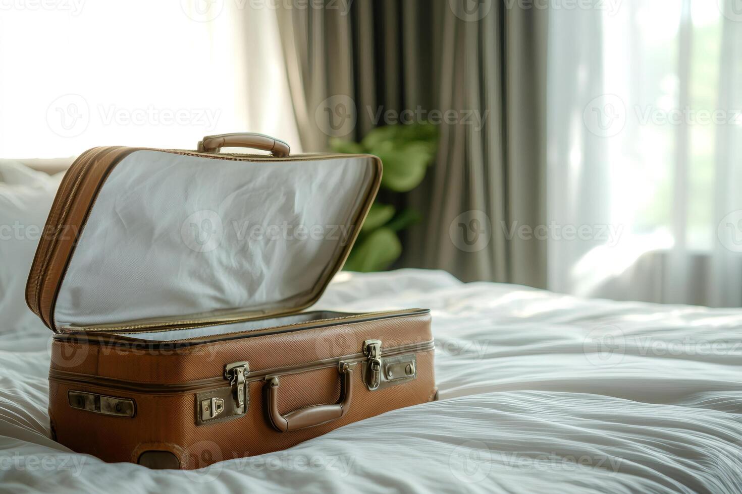 Open suitcase lying on bed invites to pack for exciting journey photo