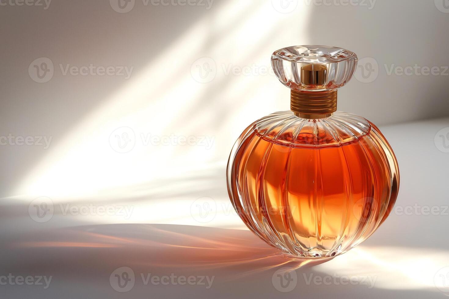 Elegant perfume bottle casting shadows on white surface photo