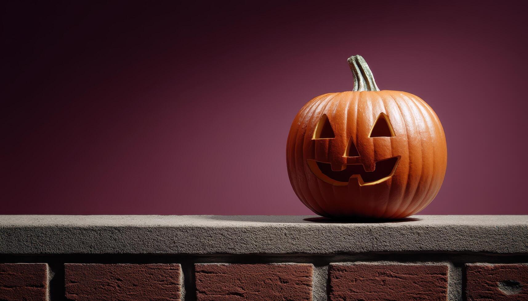 Glowing jack-o'-lantern at dusk on a stone wall halloween decoration indoor environment close-up view photo