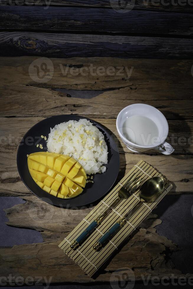 Street food with sticky rice and ripe mangoes is very delicious and popular among Thai people. It is Thai food. photo
