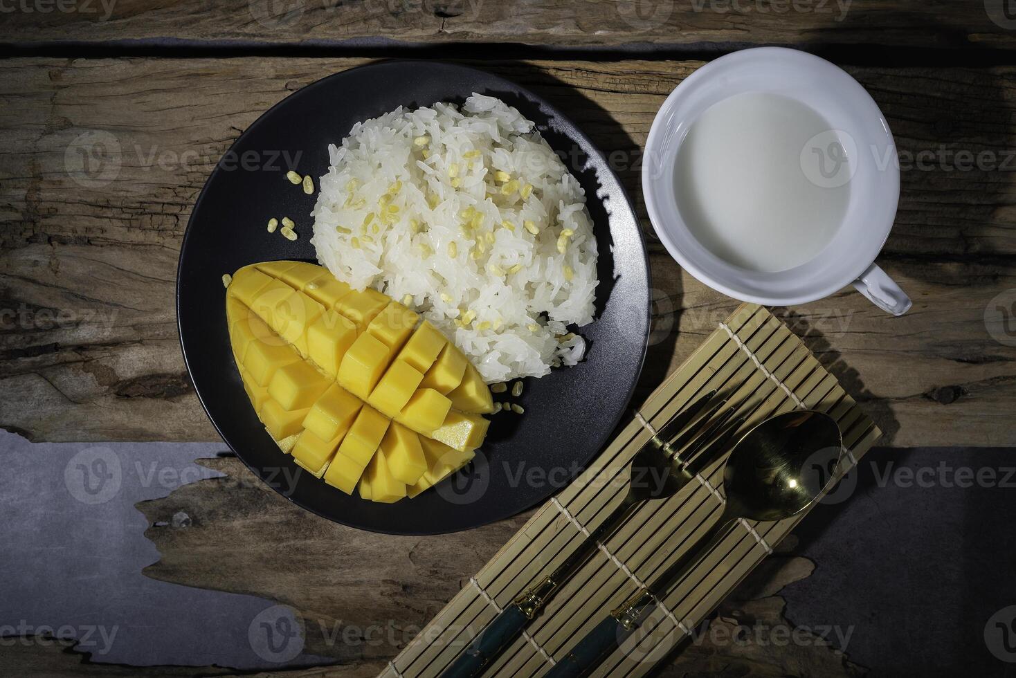 Street food with sticky rice and ripe mangoes is very delicious and popular among Thai people. photo