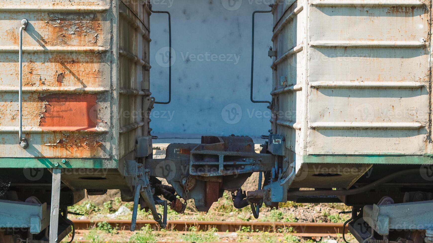 Two old freight train cars connected, showing industrial transport elements photo