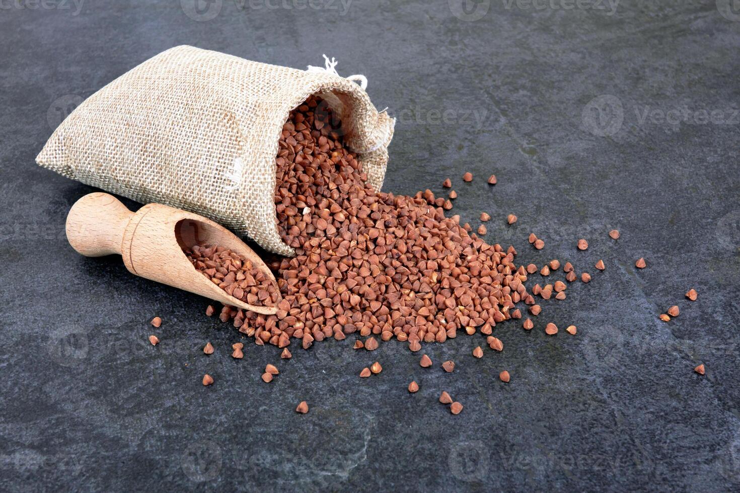 Raw buckwheat on black as a background photo
