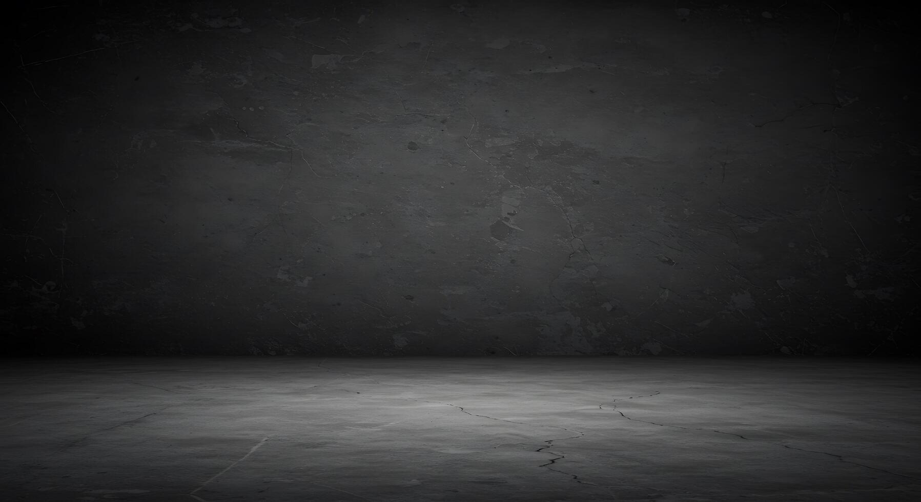 An empty room with a dark wall and concrete floor photo