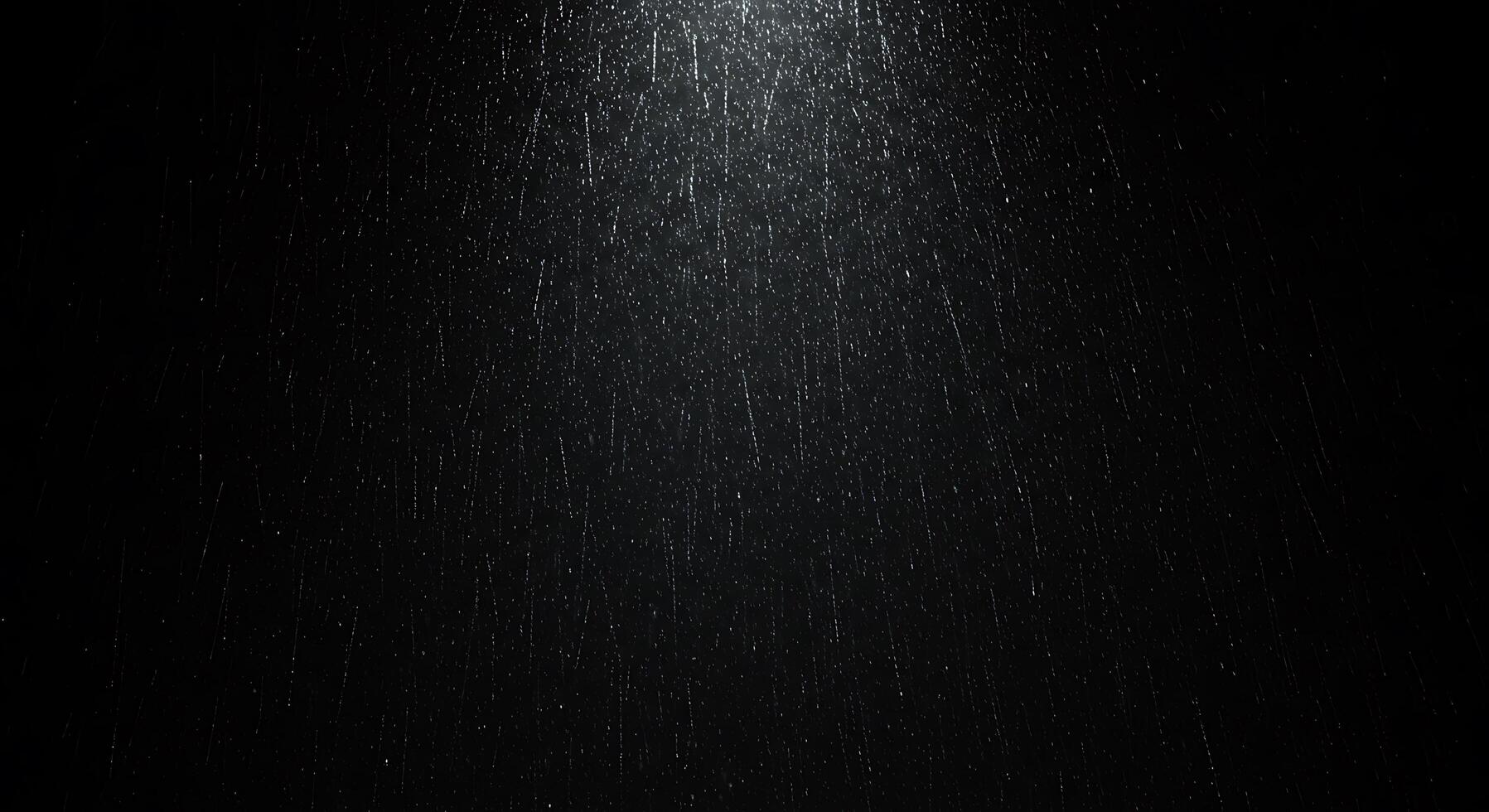 Rain falling on a black background photo