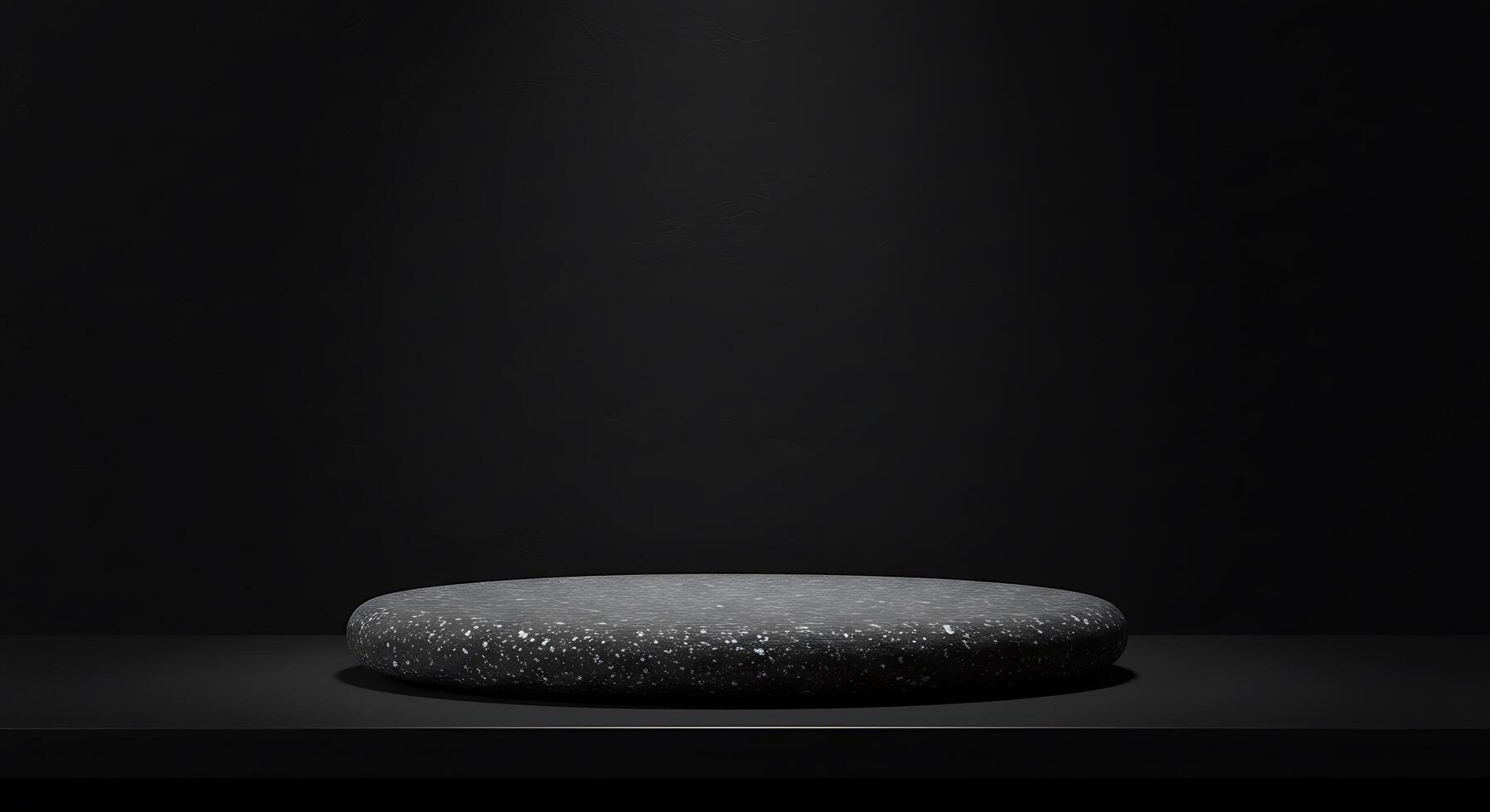 A black stone table sitting on a black surface photo
