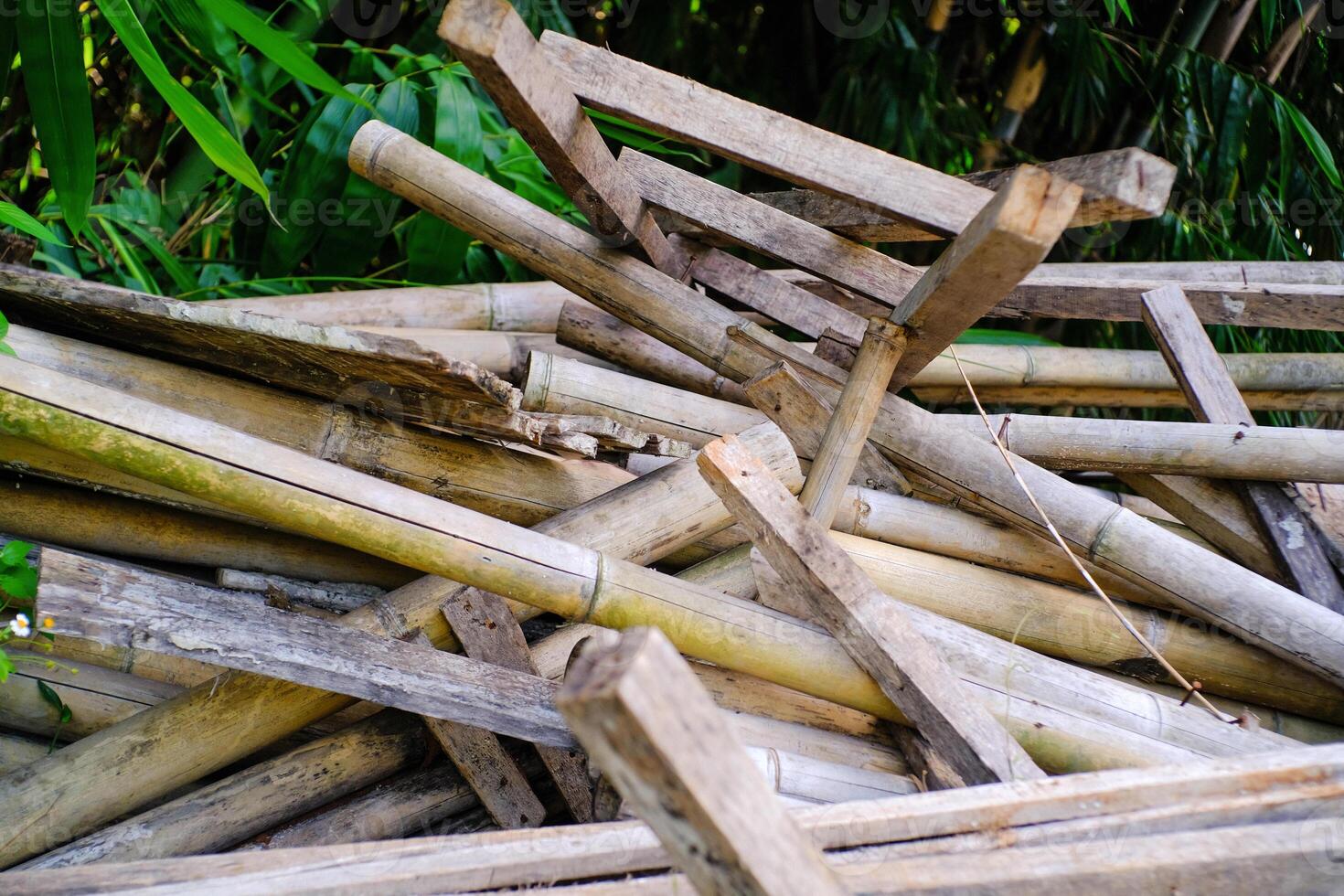 Demolition of illegal huts. Piles of wooden blocks and planks scattered around. Wooden blocks, planks, and bamboo poles after demolishing houses. Restructuring and reconstruction photo