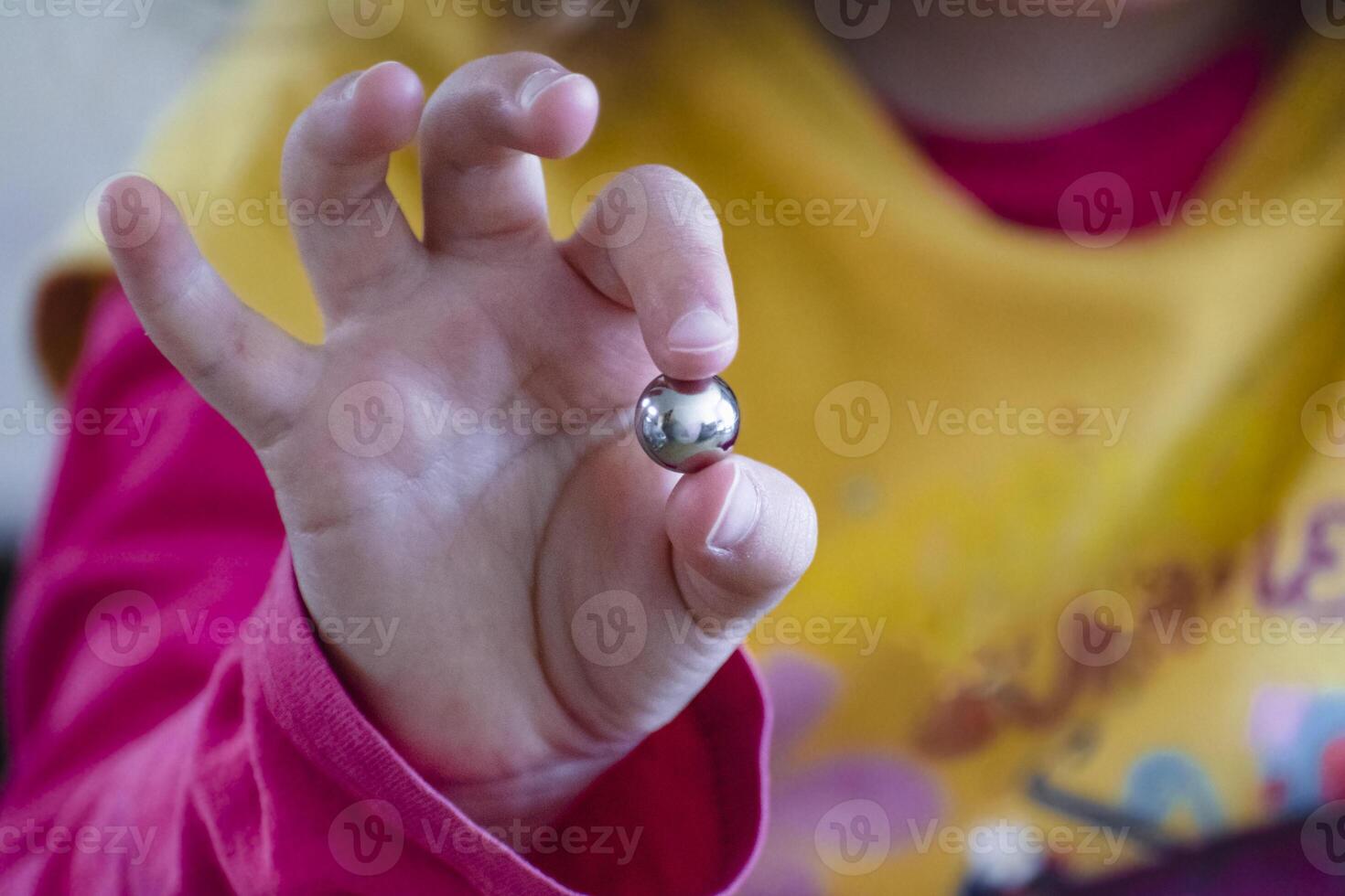 Child having fun with an authentic leisure activity, fine motor skills development, learning photo