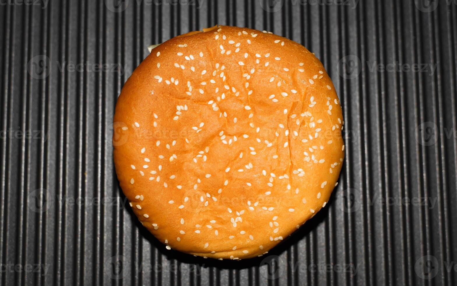 A hamburger on a black surface photo