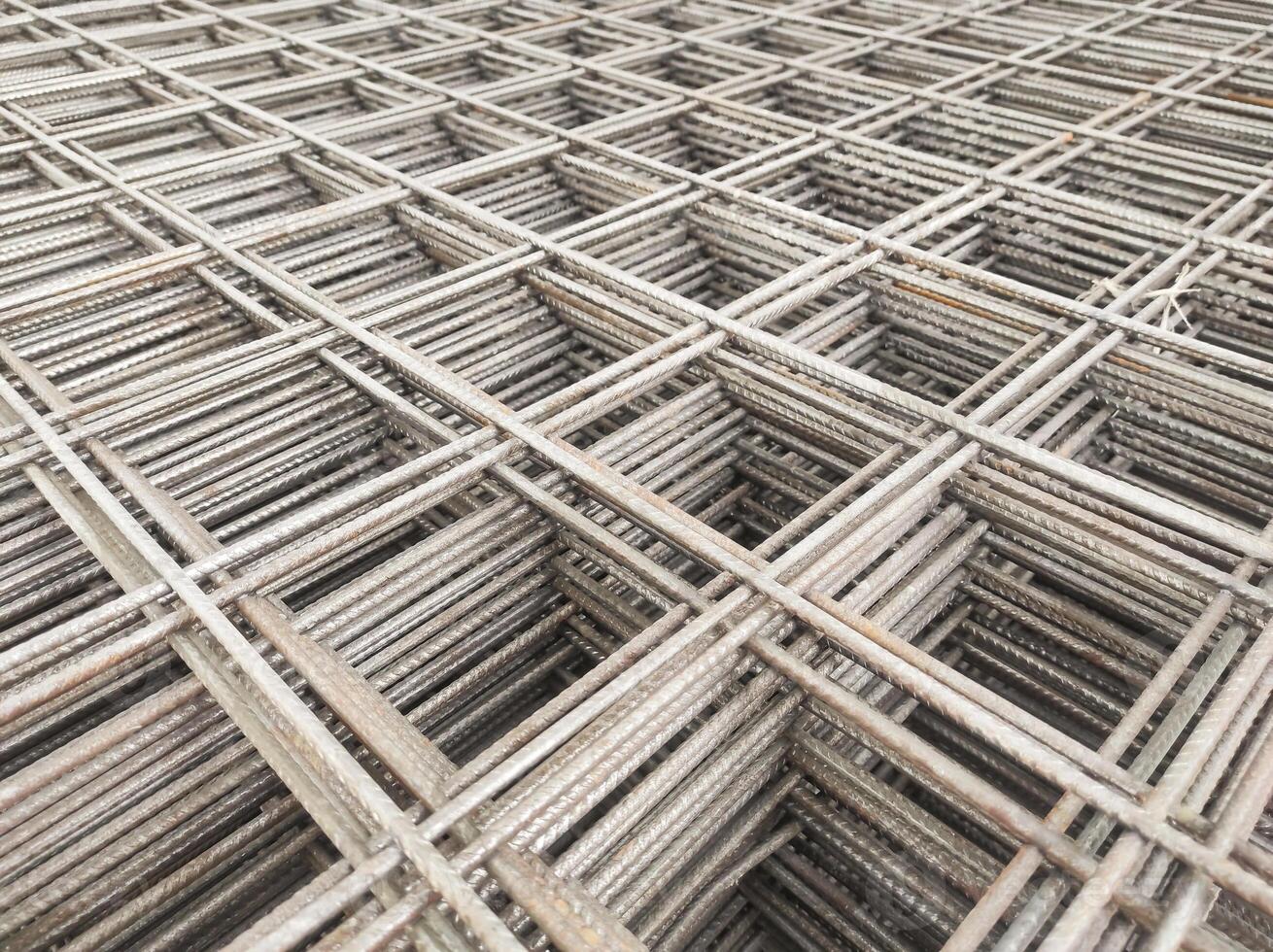 Optical illusion photo of stack of wire mesh iron. A group of cast iron forms a rectangle with three-dimensional depth. Construction Industry. Hardware and building materials store.