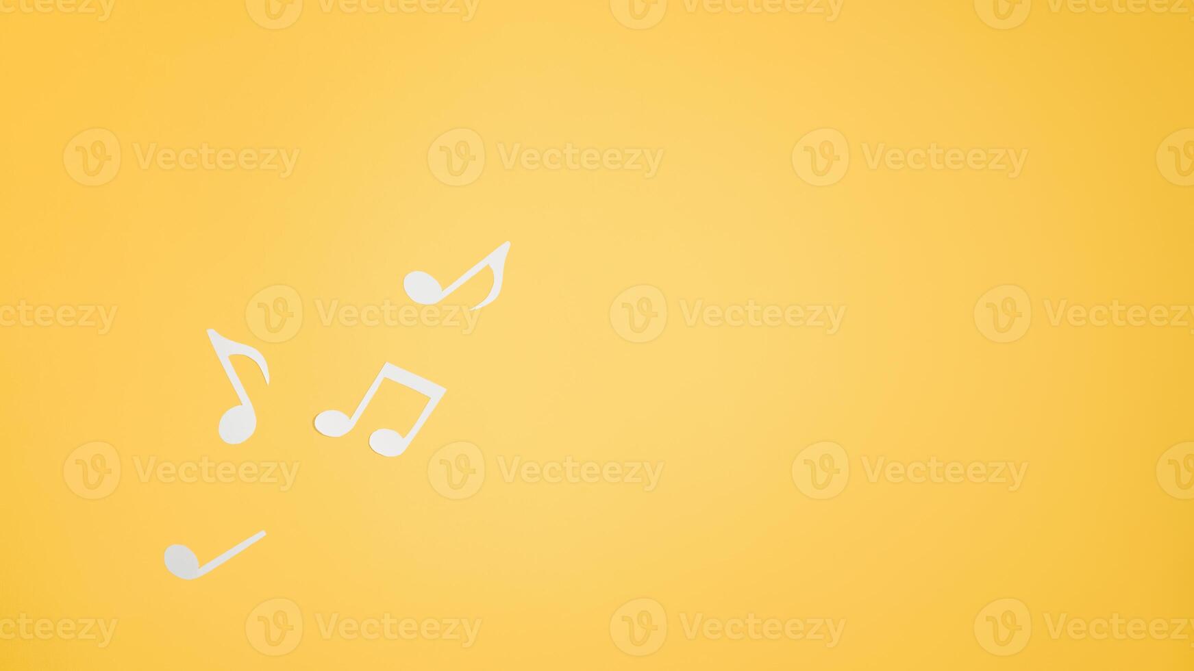 Musical notes cut from paper, flat lay. Top view music layout on yellow background. Place for text photo