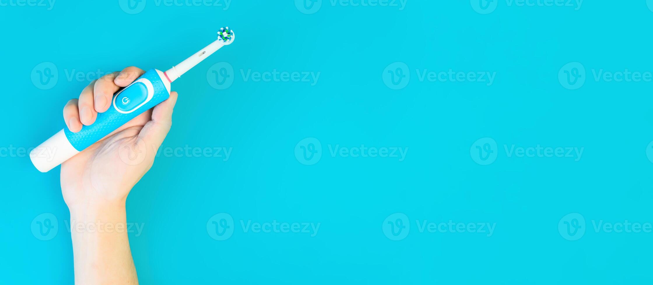 Hand showing modern toothbrush. Electric oral care instrument. Banner, copy space. Space for text on the right photo