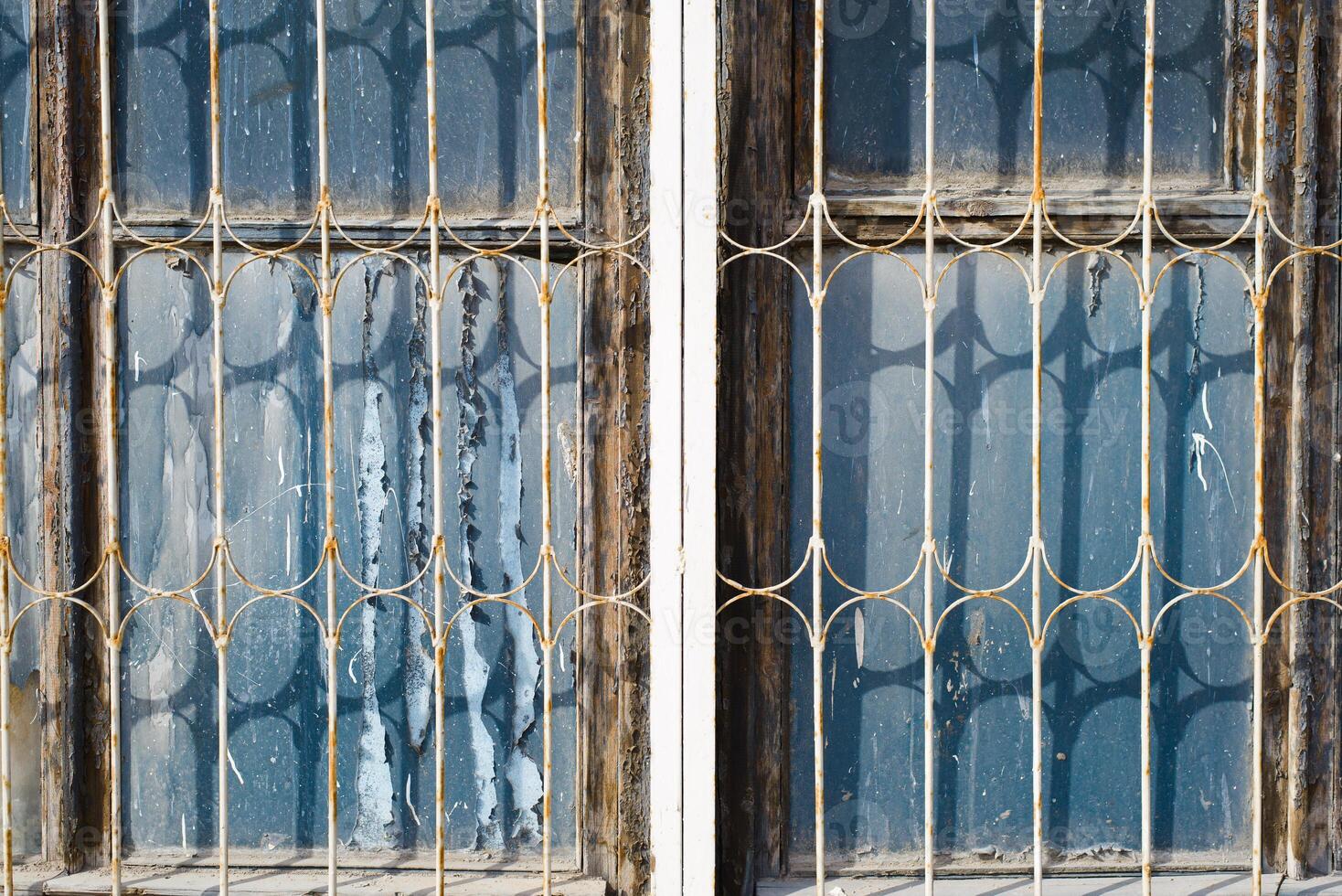 Two windows with bars on them photo