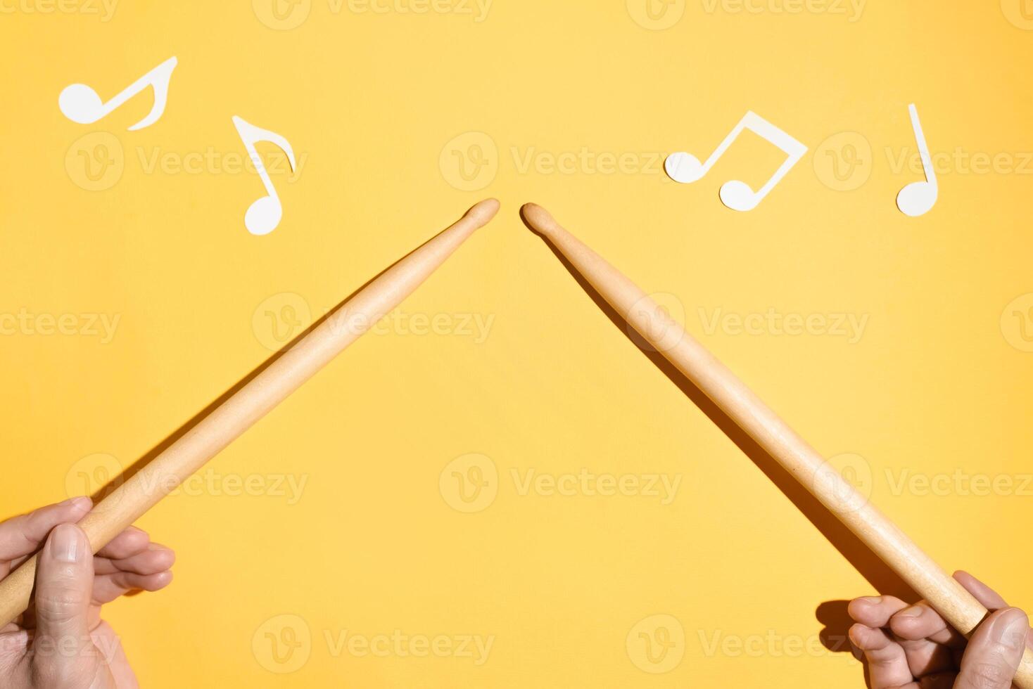Drummer concept. Male hands holding drum sticks and notes from paper. Flat lay photo