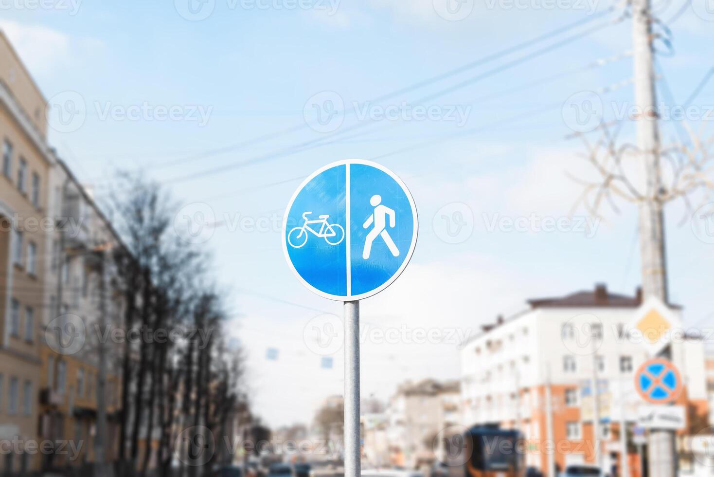 A blue and white sign on a pole photo