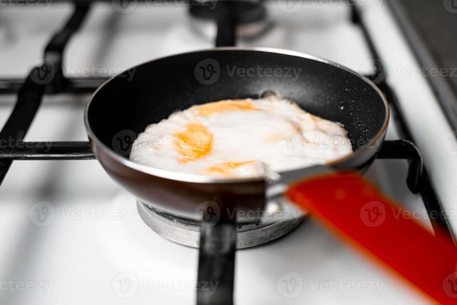 An egg is being cooked in a frying pan photo