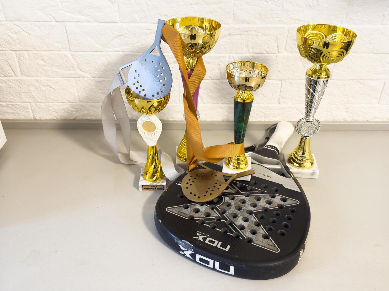 January 23, 2025, Kyiv, Ukraine - Gold cup with sports equipment padel racket photo
