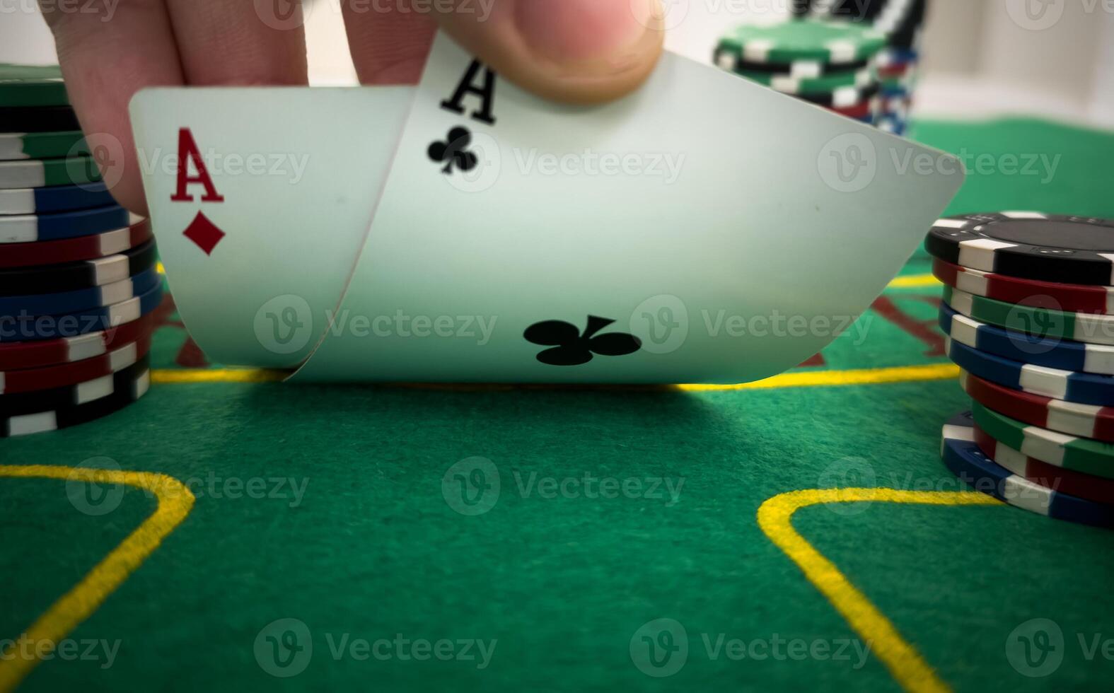 player shows playing cards against the background of playing chips on a green table in a casino close-up photo