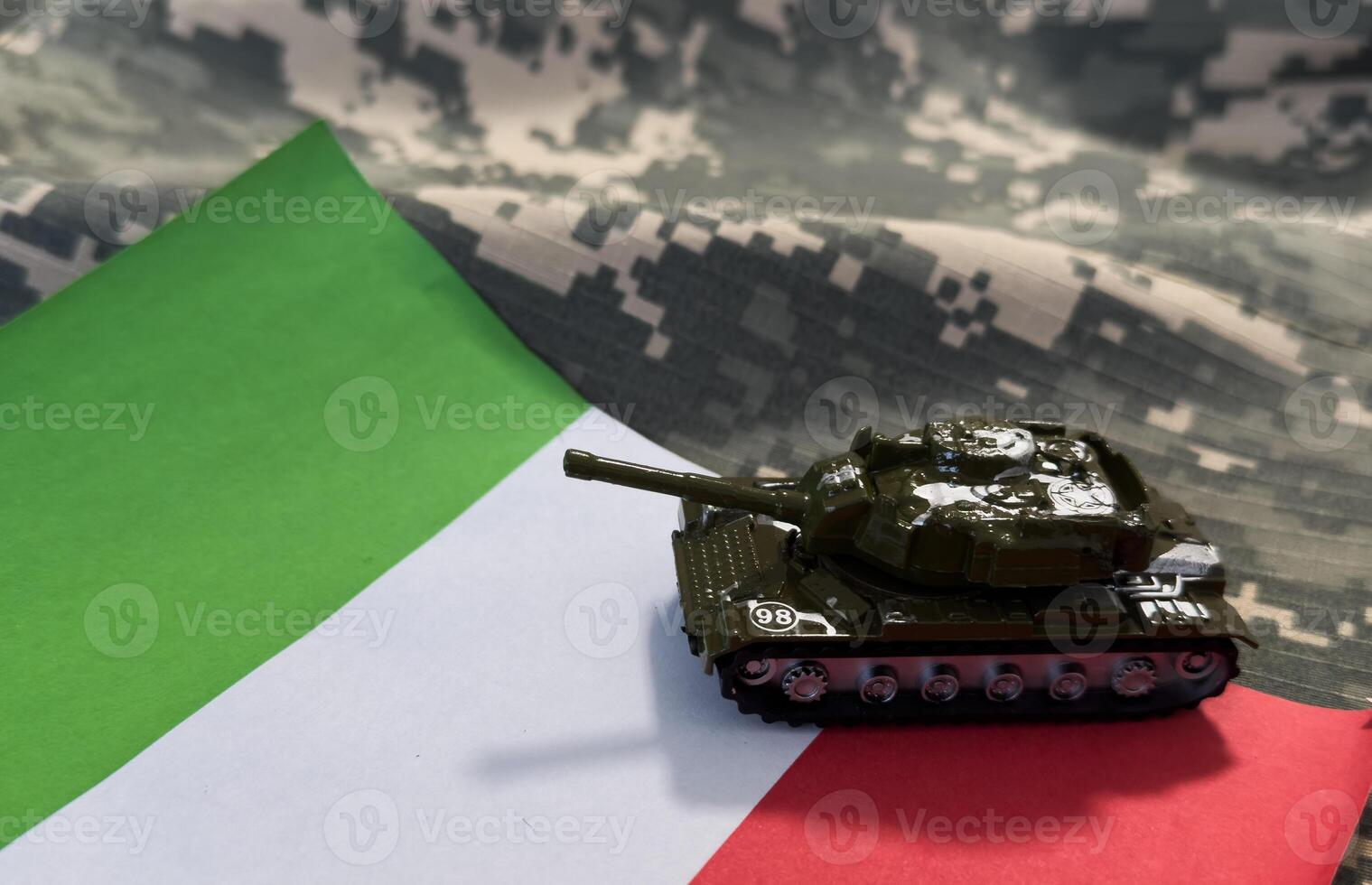 Tank toy near Italian flag on military background photo