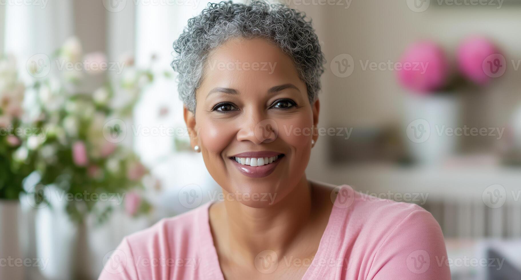Smiling woman in pink sweater with a cozy and floral background photo