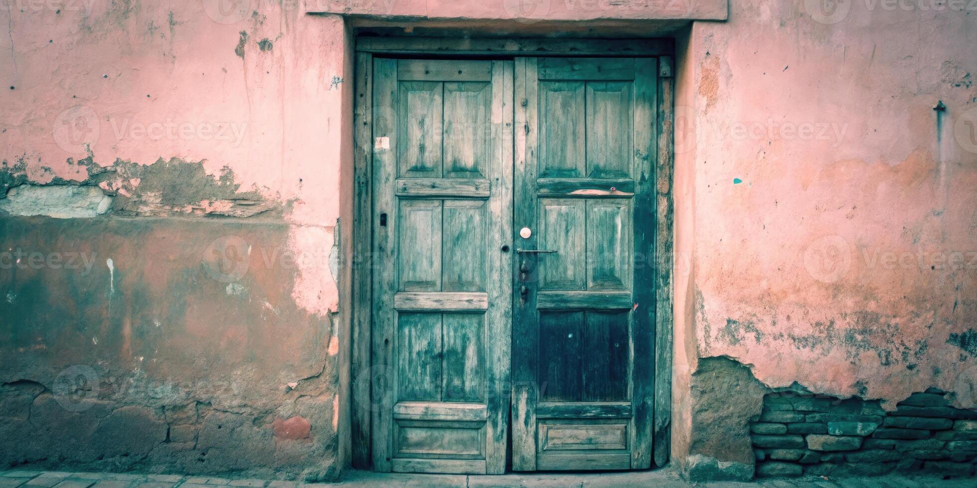Weathered green door on a rustic wall. photo