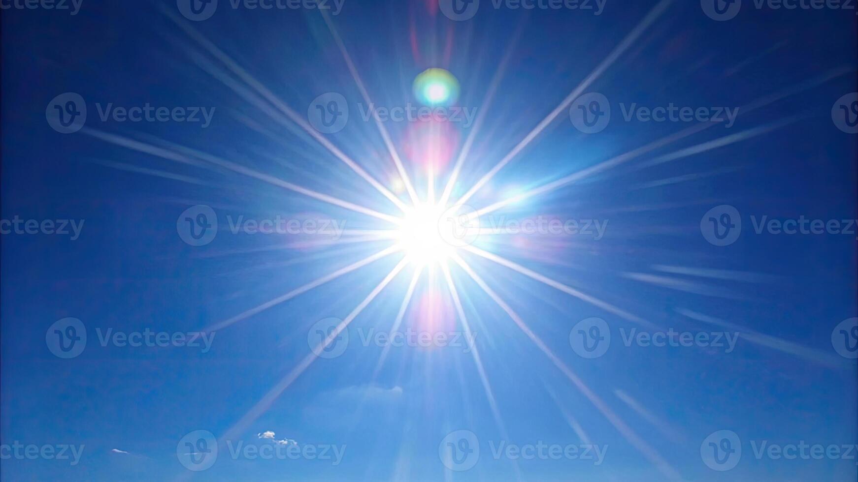 Bright sunburst with rays against a clear sky. photo