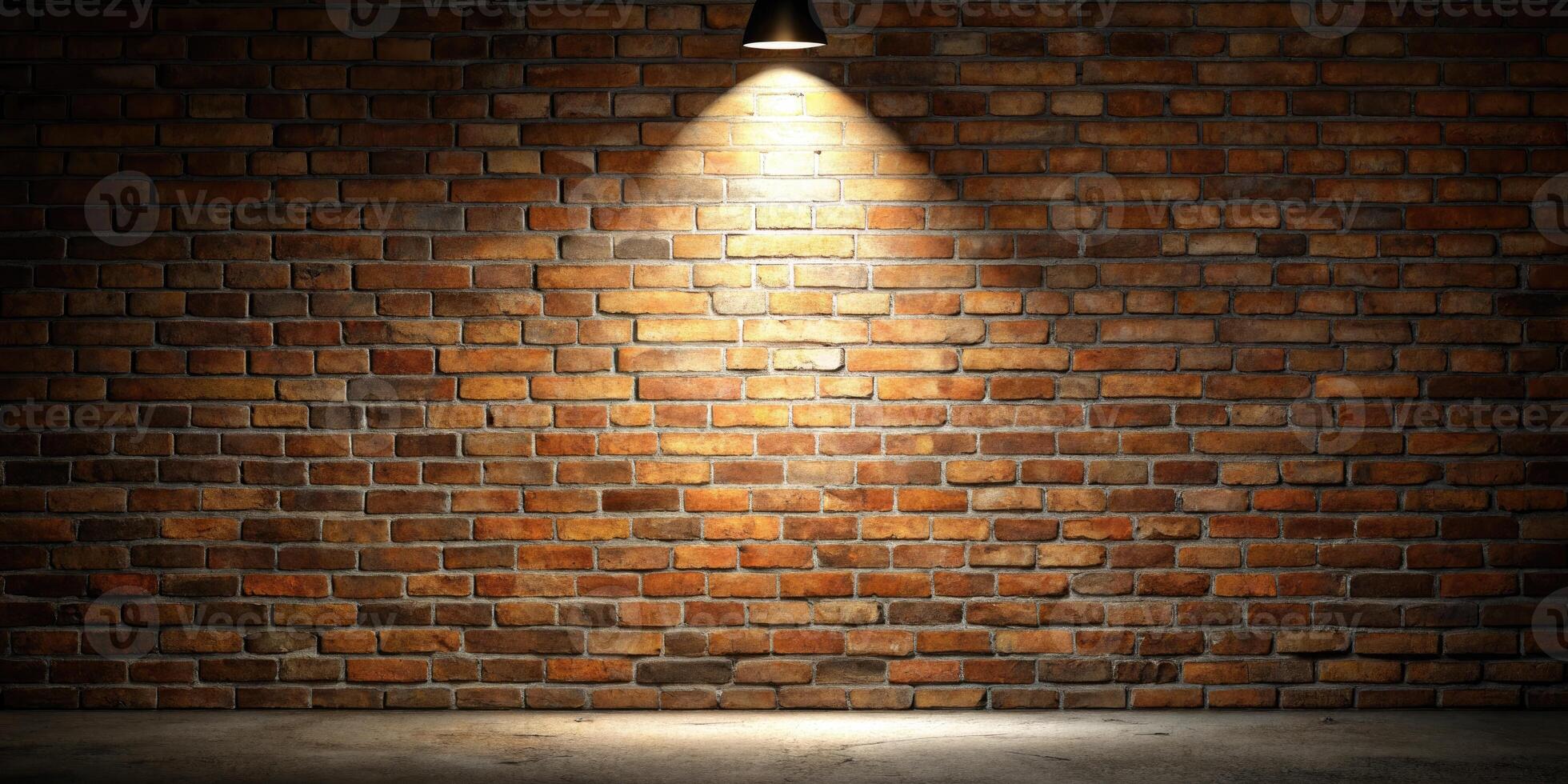 Rustic brick wall illuminated by a single spotlight. photo