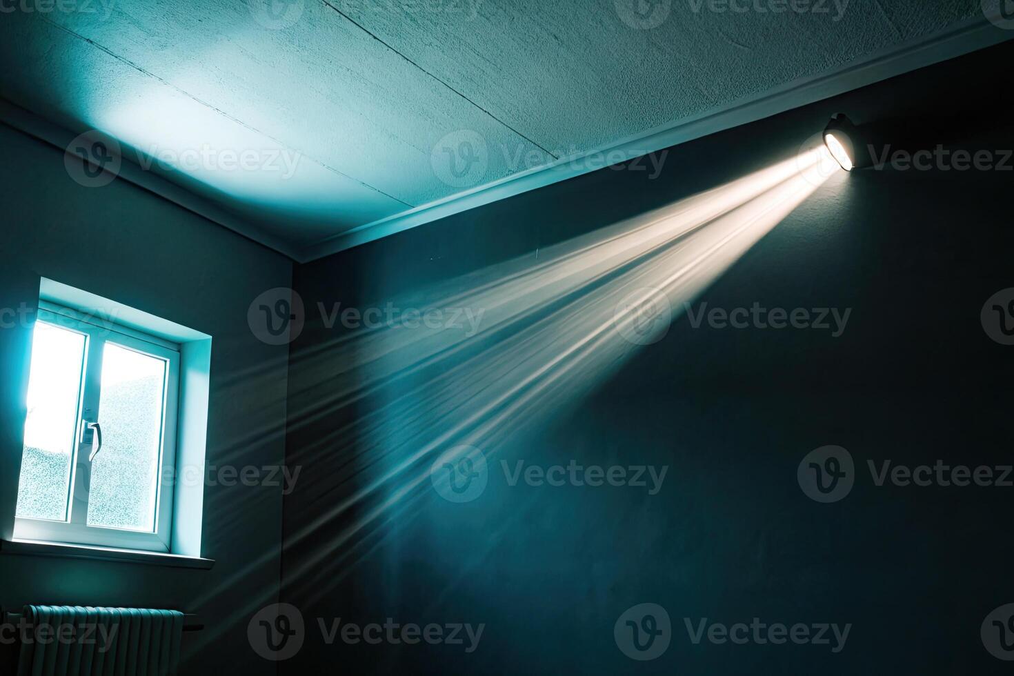 A single beam of light pierces through a dimly lit room. photo