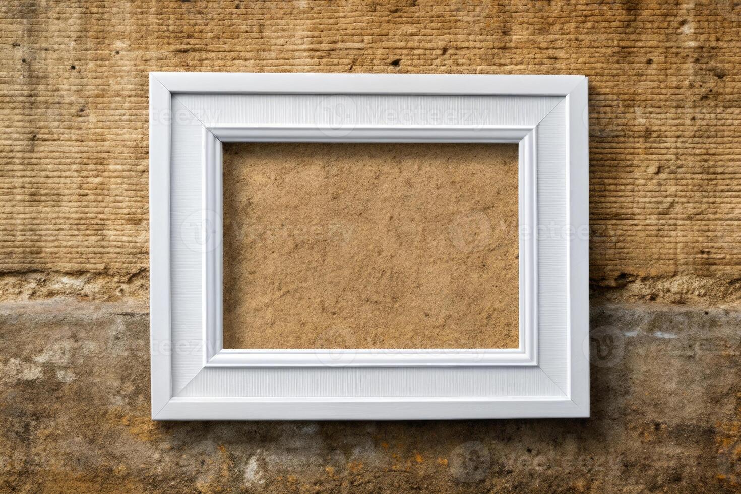 An empty white picture frame against a rustic wall. photo