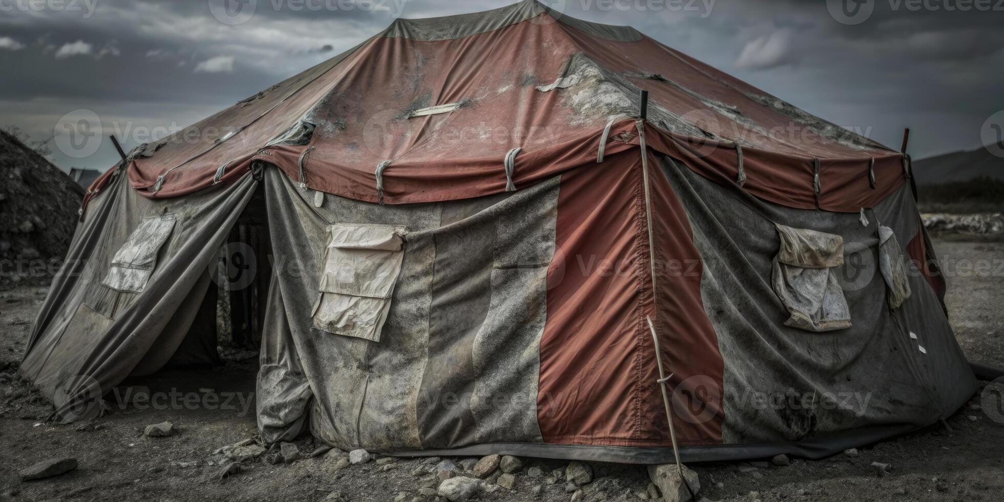 A weathered circus tent set up on a cloudy day. photo