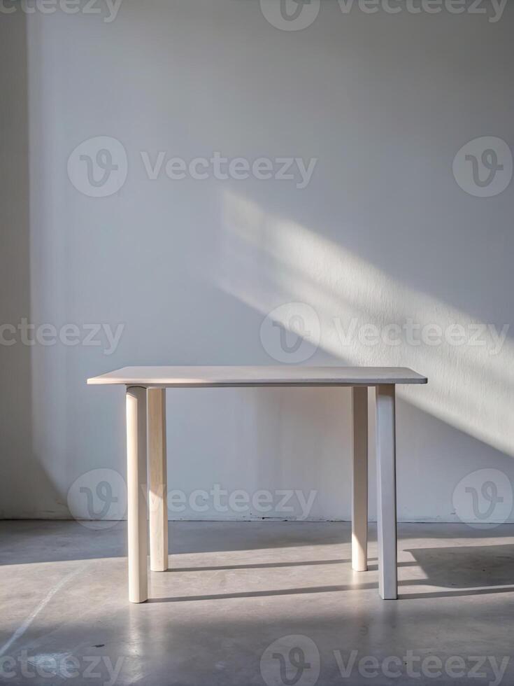 Minimalist white table casting a shadow on the wall. photo