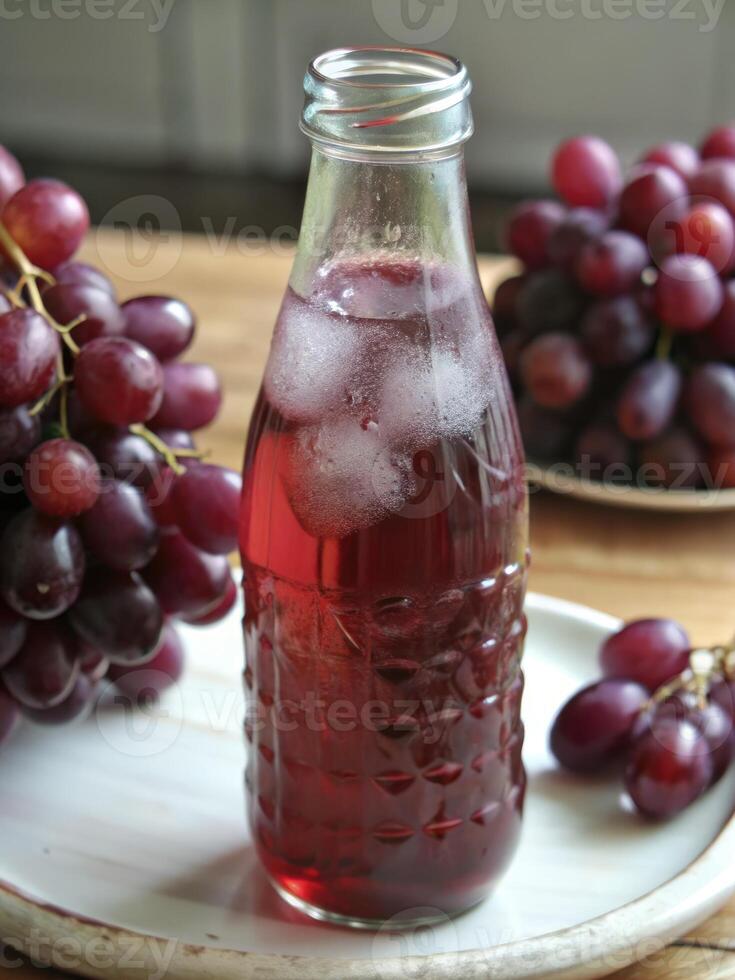 Refreshing bottle of grape juice on a wooden table. photo