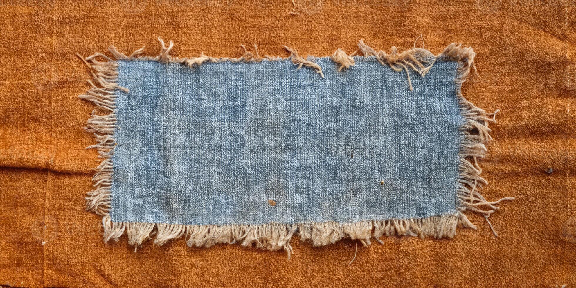 Rustic blue fabric with frayed edges on a wooden table. photo